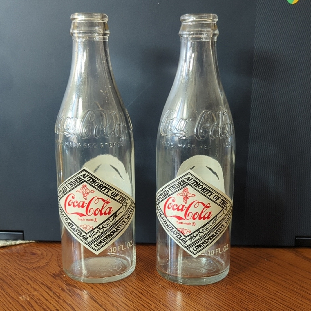 Two Vintage Anniversary Coke Bottles